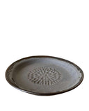 Ceramic plate with a textured design on a white background
