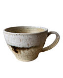 Two ceramic cappuccino cups with beige, bronze, and pink speckled glaze, stacked on top of each other.