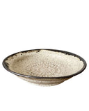 Ceramic bowl with textured surface on a white background
