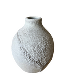 Three porcelain crater vases in beige, white, and black colors, each with a textured, frothy glaze.