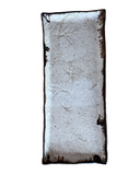 A rectangular stoneware serving platter with a bronze accent at the lip and a subtle woven texture, primarily in a brown color.