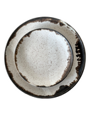 A set of handcrafted stoneware plates with a speckled brown finish and a bronze lip.