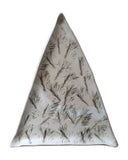 A triangular ceramic dish with a textured, hand-painted pine needle pattern in dark gray and black on a warm off-white glaze, set against a plain white background.