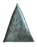 A handmade triangular ceramic plate with a textured, metallic teal-green glaze and dark brown botanical leaf patterns, shown on a plain white background.