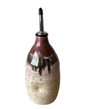 Decorative ceramic oil bottle with a metallic cap on a white background