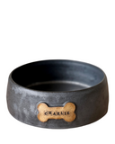A set of three custom dog bowls in sizes, each with a bone-shaped name plate, in matte black color.