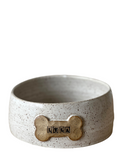A set of three custom dog bowls in sizes, each with a bone-shaped name plate, in matte black color.
