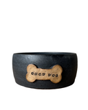 A set of three custom dog bowls in sizes, each with a bone-shaped name plate, in matte black color.