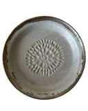 Ceramic plate with a sunflower design on a white background