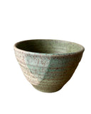 Green ceramic bowl on a white background