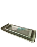 A rectangular ceramic serving tray with a raised center ridge, shown in a speckled light gray and beige glaze with a subtle mint-green accent on the inside, isolated on a white background.