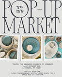 A promotional poster for Pop-Up Market, featuring large black typography on a light gray background and three inset photos of ceramic tableware and dishes. Text at the bottom provides the event date, location, and hours.