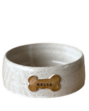 A set of three custom dog bowls in sizes, each with a bone-shaped name plate, in matte black color.