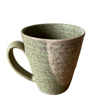 Speckled ceramic mug on a white background