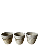 Three ceramic cups with a speckled finish on a white background