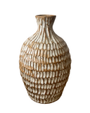 Decorative vase with textured design on a white background