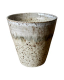 Speckled ceramic planter on a white background