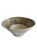 Ceramic bowl with textured brown rim on a white background