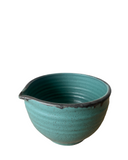 Teal ceramic bowl on a white background