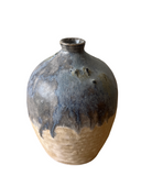 Stoneware vase with blue and brown glaze on a white background