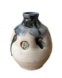 Ceramic vase with blue and black patterns on a white background