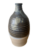 Stoneware bottle with blue and brown glaze on a white background