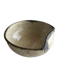 Speckled ceramic bowl on a white background