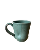 Green ceramic mug on a white background