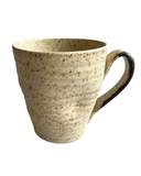 Ceramic mug in beige on white background