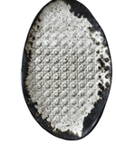 Decorative ceramic plate with textured surface on a white background