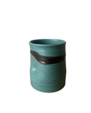 Teal ceramic cup with a brown accent on a white background