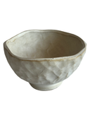 Ceramic bowl with textured surface on a white background