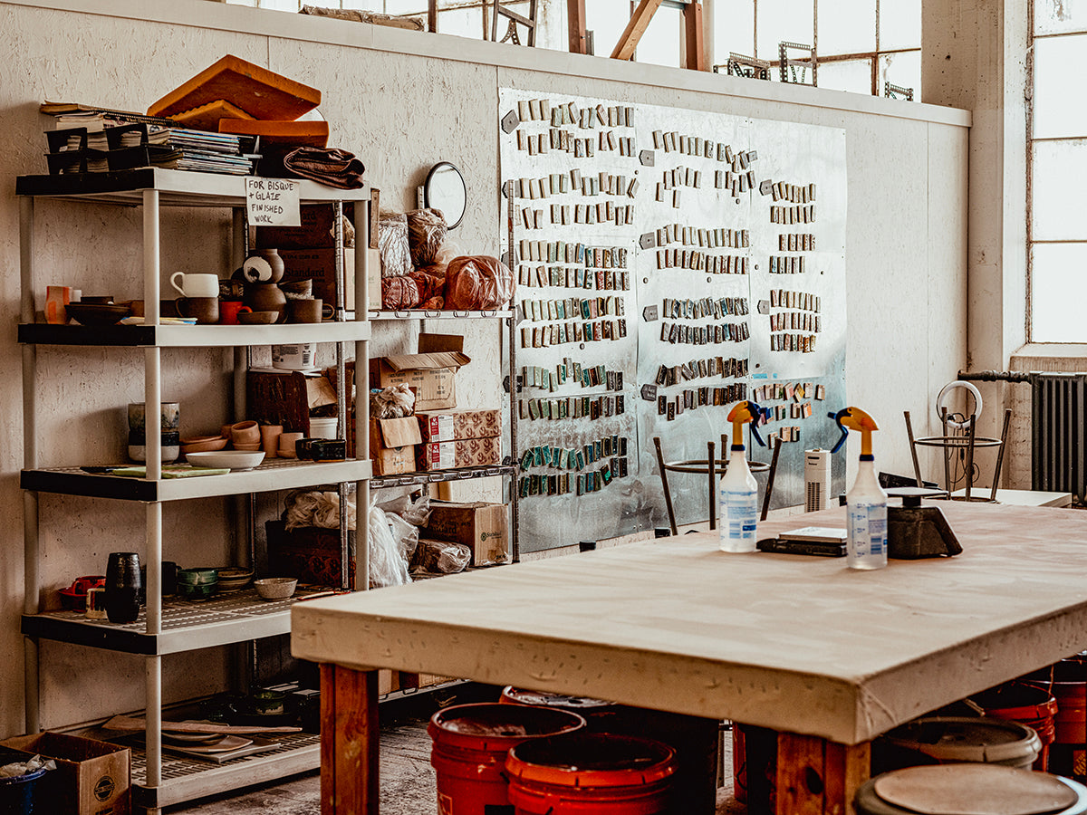 Workshop or studio with shelves, a table, and various items.