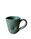 Green ceramic mug on a white background