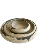 Two ceramic bowls with speckled glaze on a white background