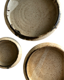 A set of three plates on a white background
