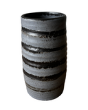 Black and gray striped ceramic vase on a white background