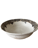 Ceramic bowl with brown and white design on a white background