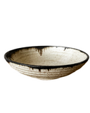Ceramic bowl with a textured surface on a white background