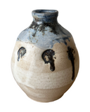 Ceramic vase with blue and black accents on a white background