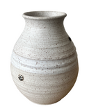 Speckled beige ceramic vase on a white background
