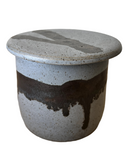 A ceramic butter crock sits on a white background.