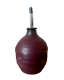 Red oil filter cleaner with a metal nozzle on a white background