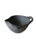 A beige ceramic batter bowl with a speckled pattern and bronze accent at the lip, crafted from brown stoneware clay.