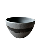 Gray ceramic bowl with black interior on a white background