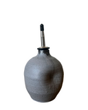 Gray ceramic container with a black and silver spout on a white background