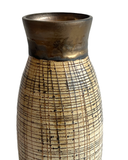 Ceramic vase with textured design on a white background