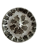 Ceramic plate with floral pattern on a white background