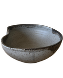 Ceramic bowl with speckled texture on a white background