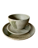 A set of plates and bowl in green on a white background. 